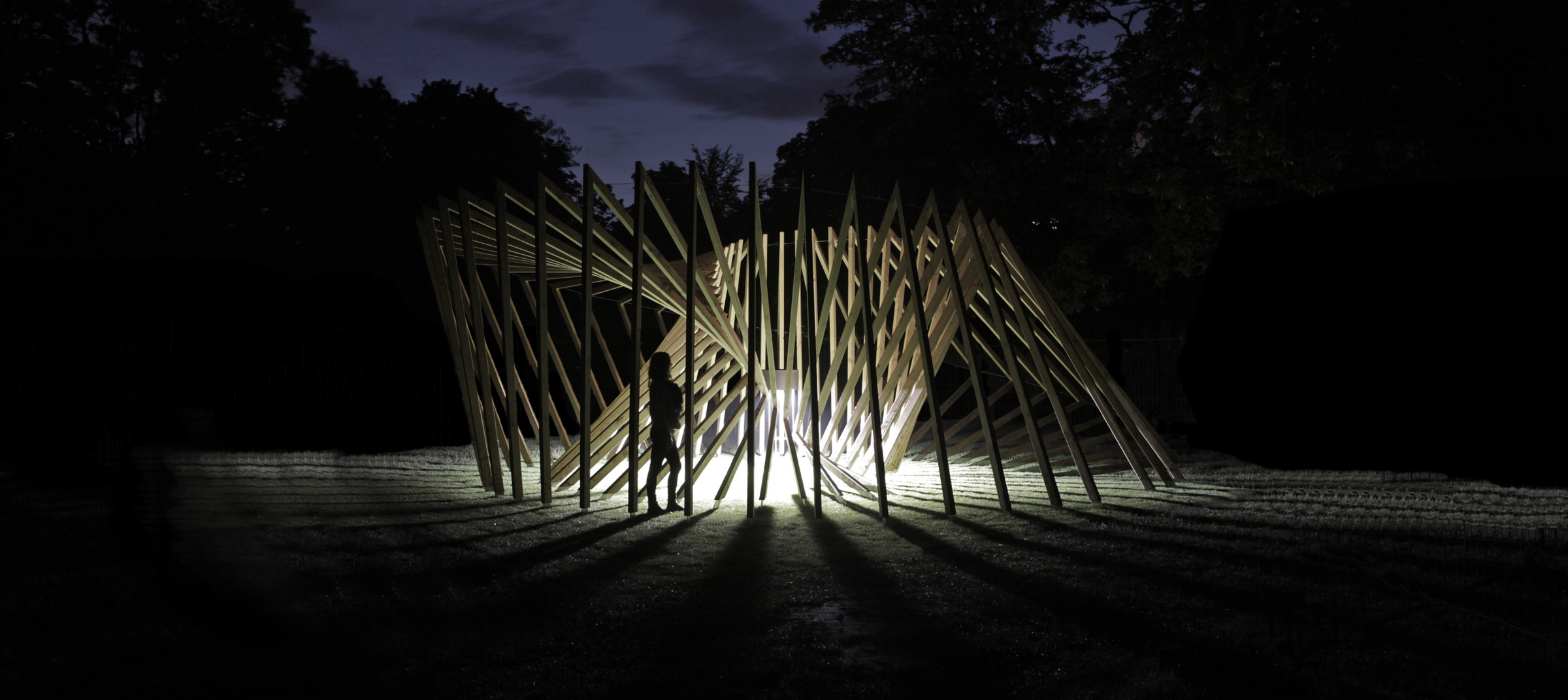 Wooden structure with triangles at night.