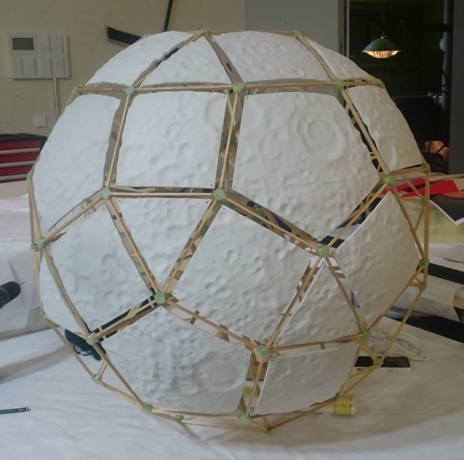 White orb with textured surface created using resin and 3D printing technology.