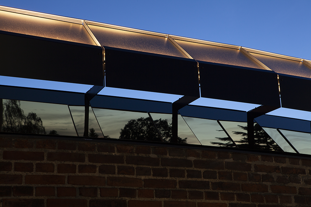 Reflection of lights on glass surface during dusk.
