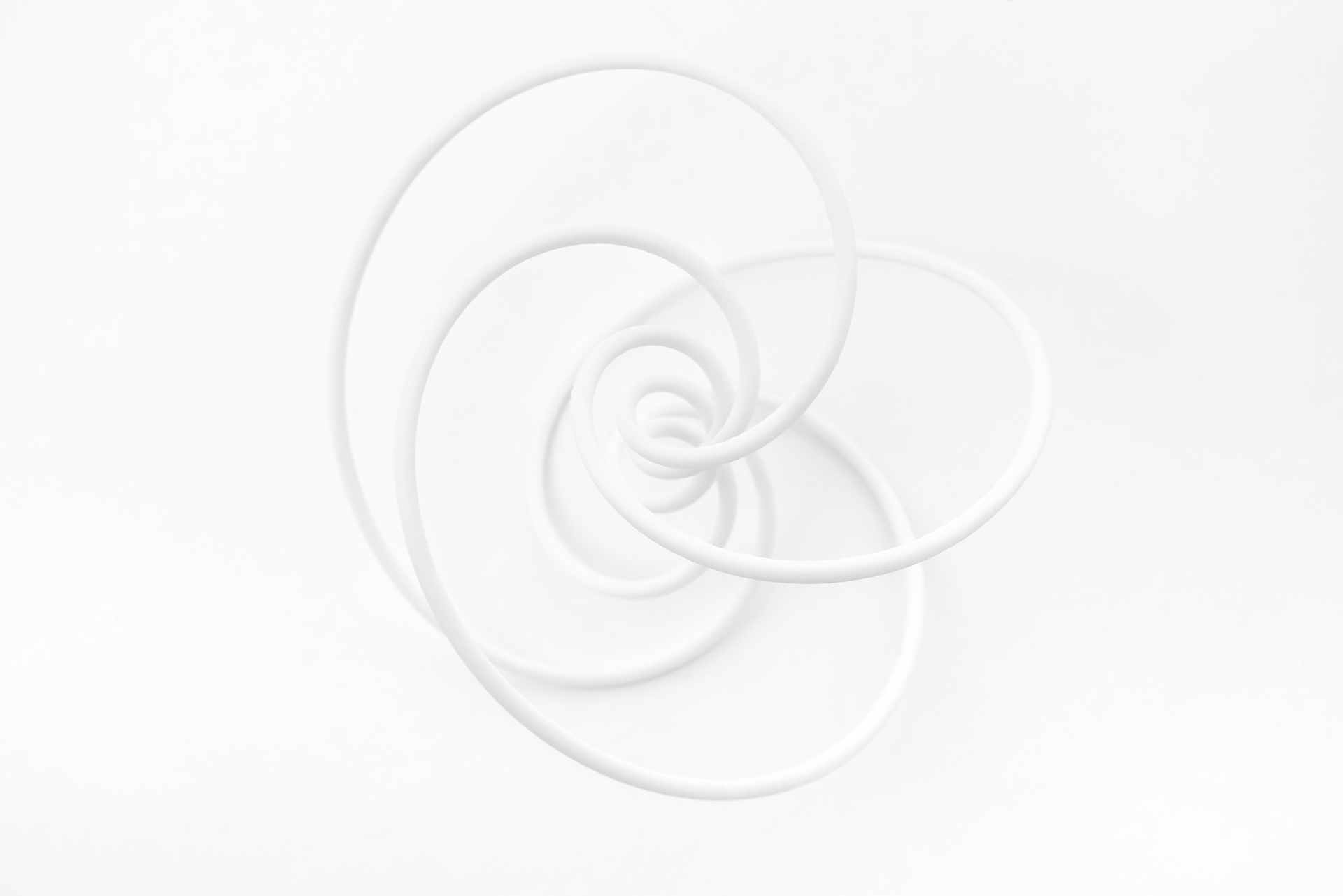 Three-dimensional knot design in white resin.