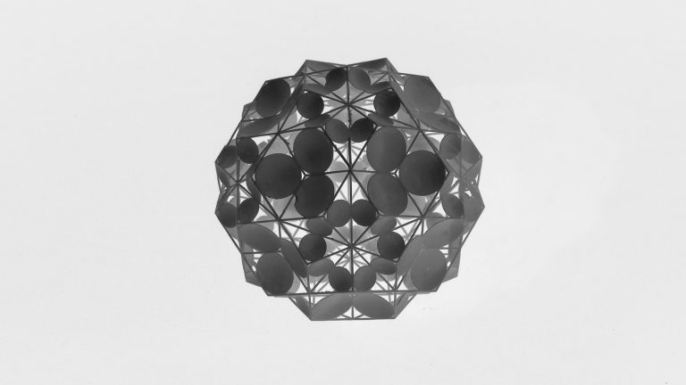 A black and white spherical sculpture made of geometric shapes.