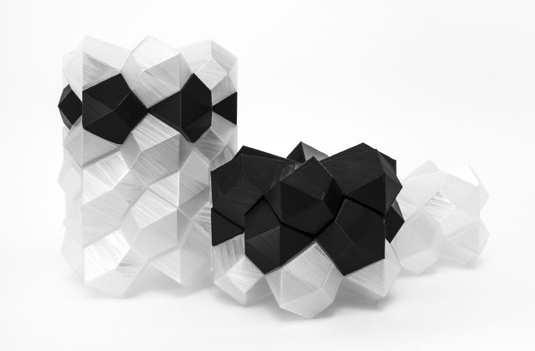 This image displays three modern sculptures made from resin and plastic.