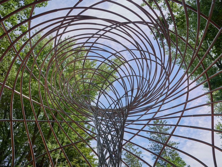 A metal sculpture with two spiral sets coiling in opposite directions.