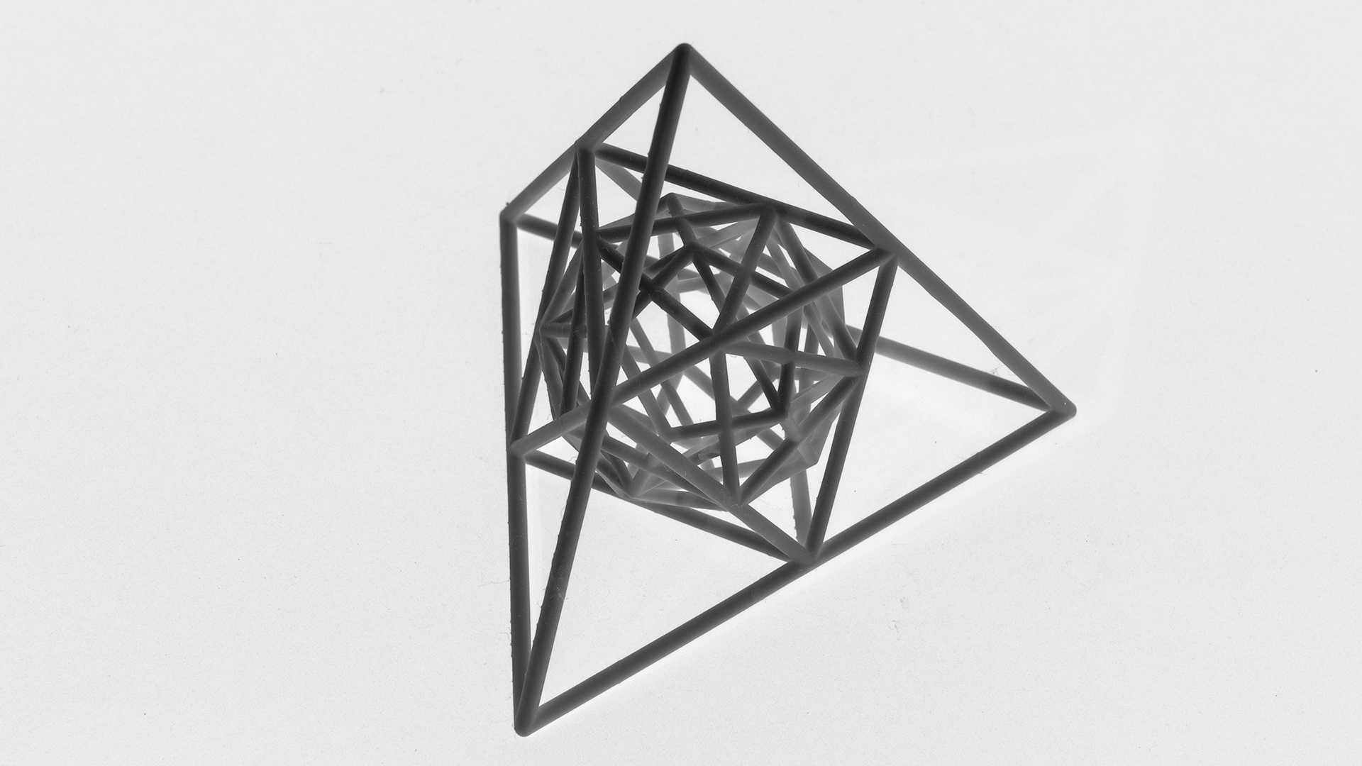 A detailed black and white sketch of a complex geometric shape composed of multiple intersecting lines and polygons.