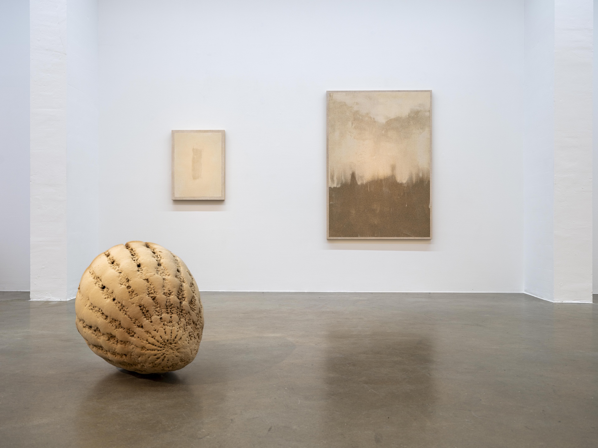 Modern art exhibition featuring a mix of sand, 3D printed, and aluminum sculptures.