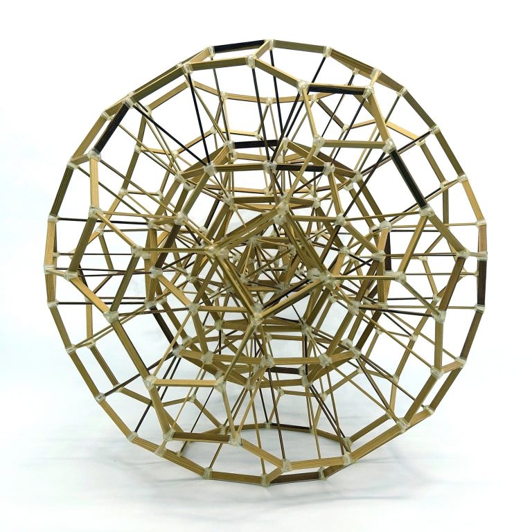 Wooden dandelion sphere sculpture in studio.