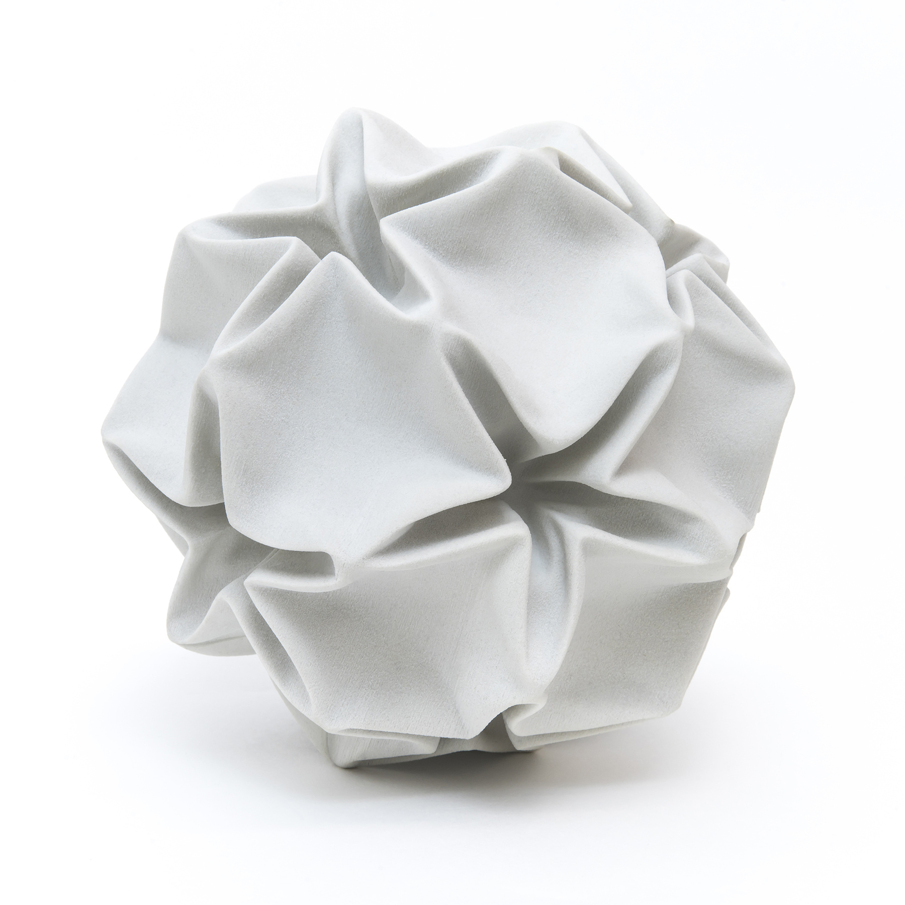 A gray plaster sculpture of a crumpled ball.