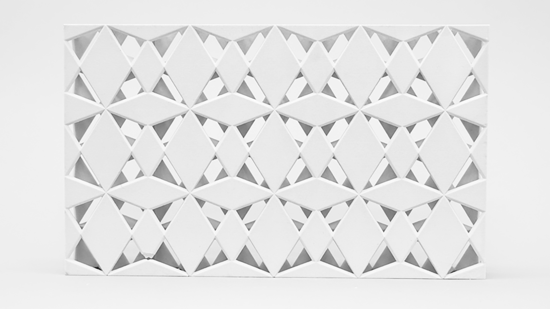 The image features a three-dimensional wall art composed of numerous white SuperCube modules arranged in an intricate pattern.
