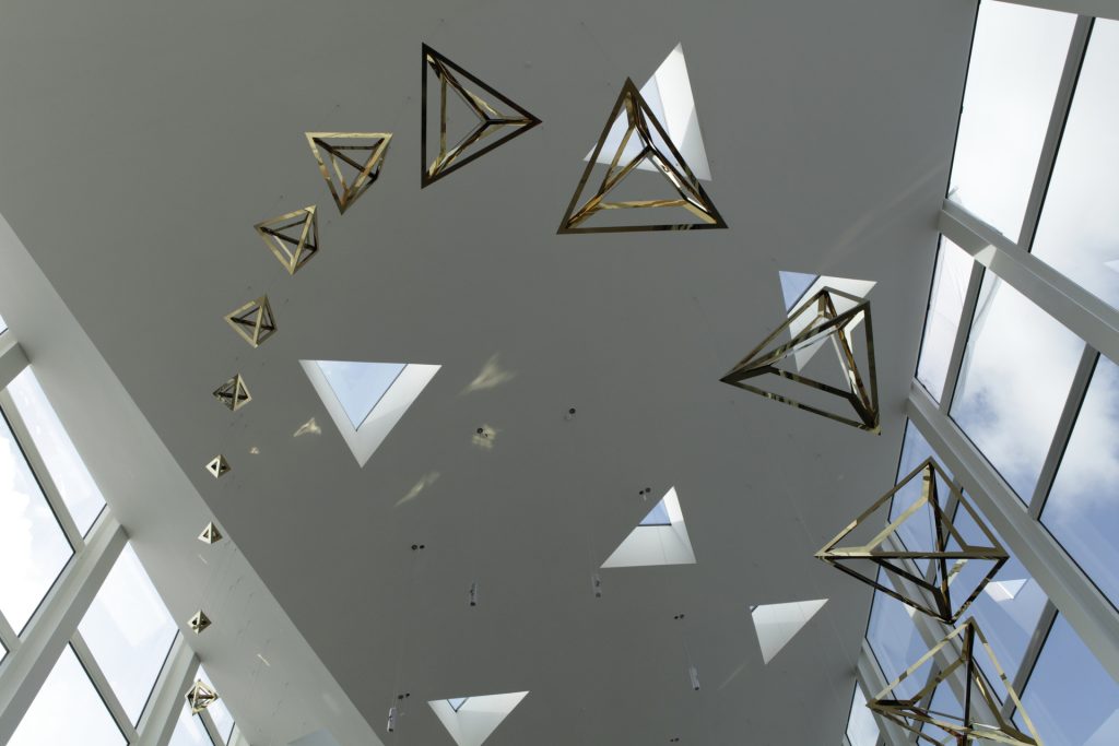 Crystal Loop, a sculpture of 36 suspended tetrahedra, hangs from the ceiling.