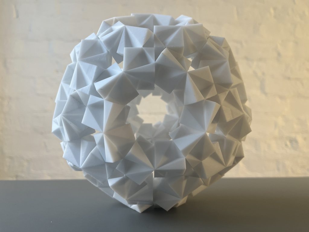 3D printed resin sculpture sits on a table.