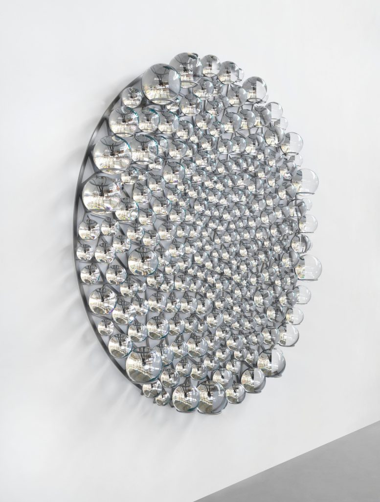 The Attention of Time" installation features partially silvered glass spheres, stainless steel, and paint.