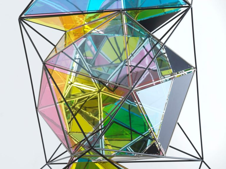 An installation made of polyhedral and compound geometric elements, and paint, is displayed.