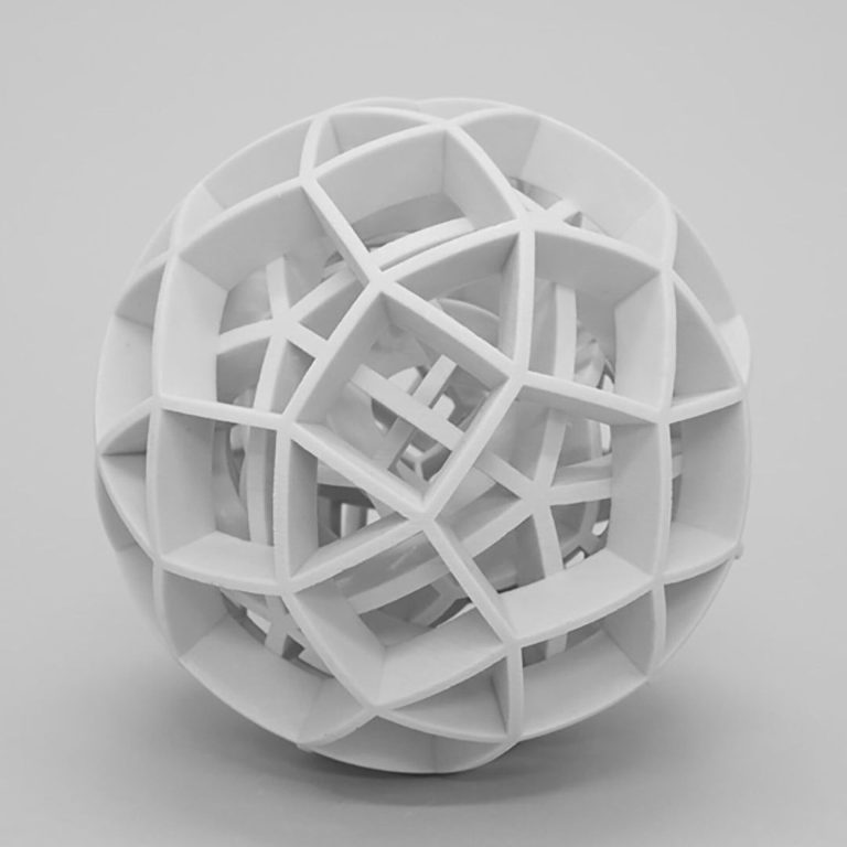 A white 3D printed resin sphere contains nested polyhedra with radial arcs and wireframes.