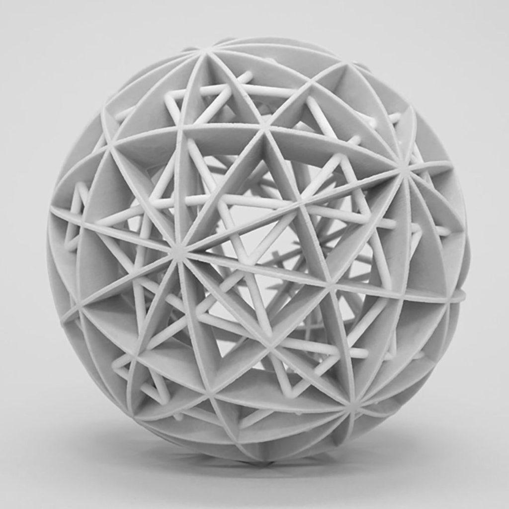 A 3D printed resin sphere displays nested polyhedra with radial arcs and wireframes.