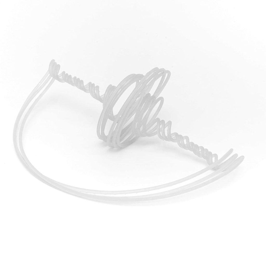 A white 3D printed resin tube forms spirals and curves on a white surface.