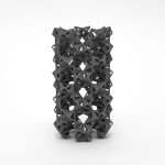 A 3D-printed resin model of stacked interlocking rings sits on a white surface.