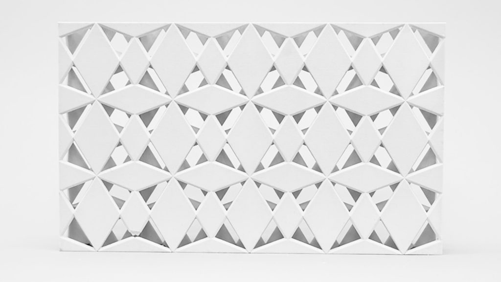A white 3D printed resin panel shows repeating diamond shapes with voids.