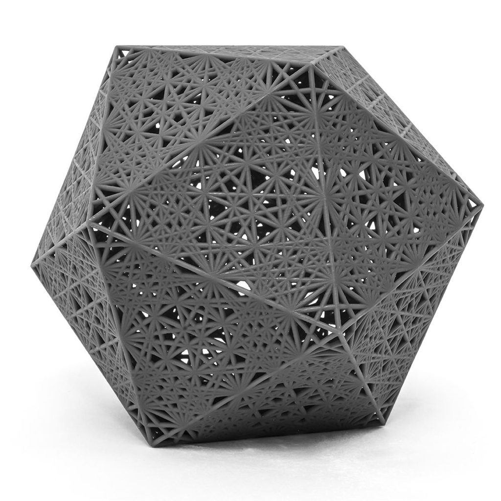 A 3D printed resin icosahedron displays a geometric lattice pattern on its surface.