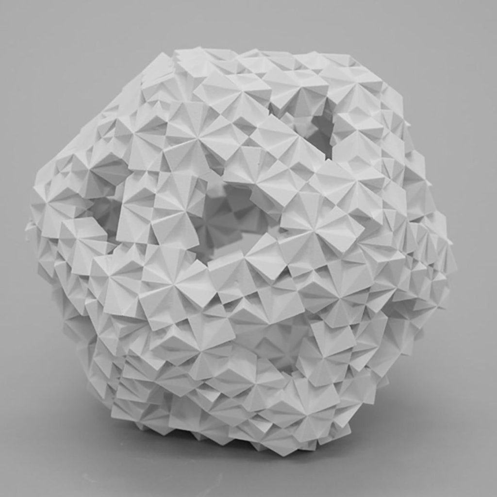 A white 3D-printed resin sphere with a geometric surface of triangular facets and three circular holes.