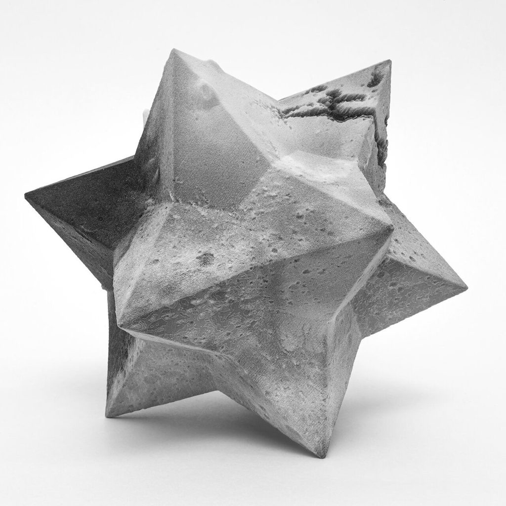 A 3D printed resin polyhedron displays Mars topography mapped onto its faceted surface.