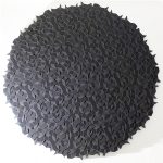 A circular resin sculpture composed of black 3D-printed geometric tiles arranged in an aperiodic pattern.