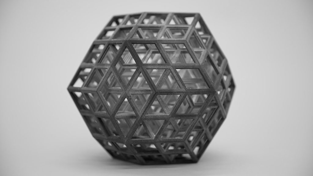 A 3D-printed resin model displays interlocking rhombic structures forming a geometric lattice.