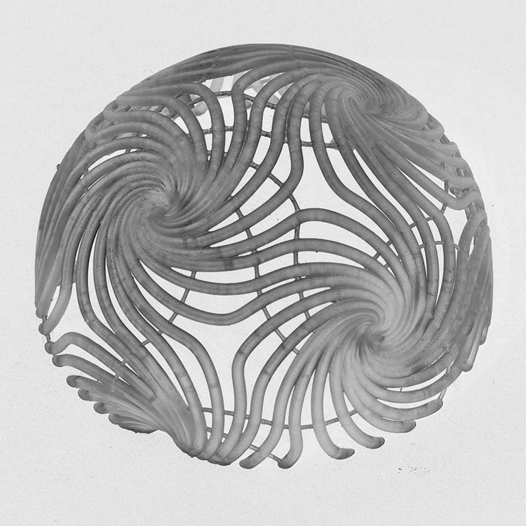 A 3d printed resin sphere has spiral patterns mapping wind flow data.