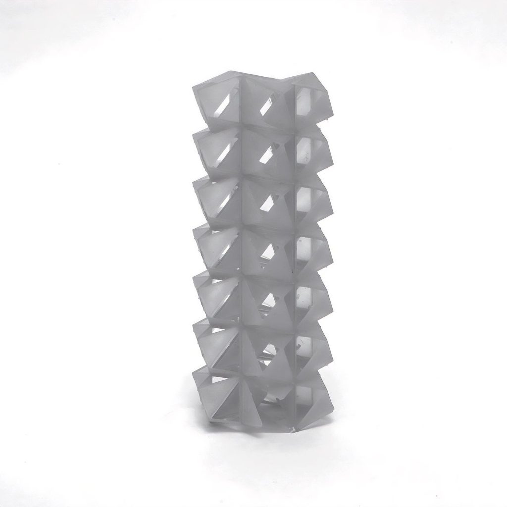 A 3D-printed resin tower stacks interlocking SuperCube rings with tetrahedral indentations.