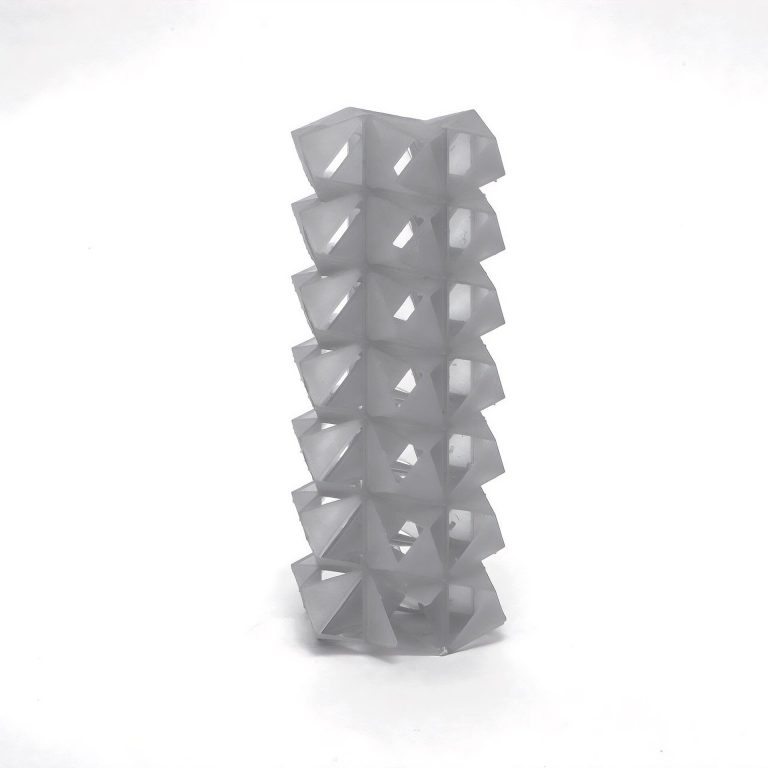 A 3D-printed resin tower stacks interlocking SuperCube rings with tetrahedral indentations.
