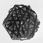 A 3D printed resin icosahedron has intersecting bars forming a geometric lattice.
