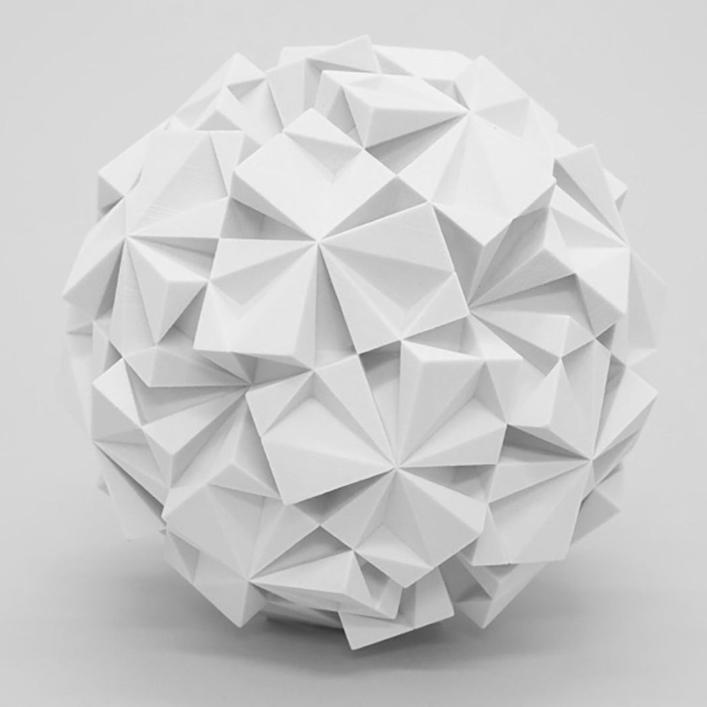 A white 3D printed resin sphere is formed by interlocking triangular facets.