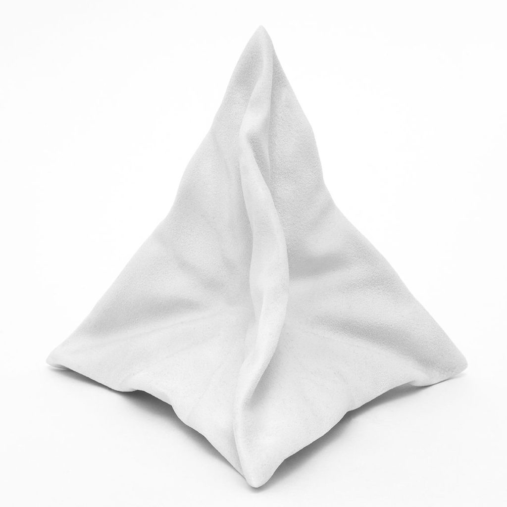 A white 3d printed resin sculpture folds into a twisted triangular shape.