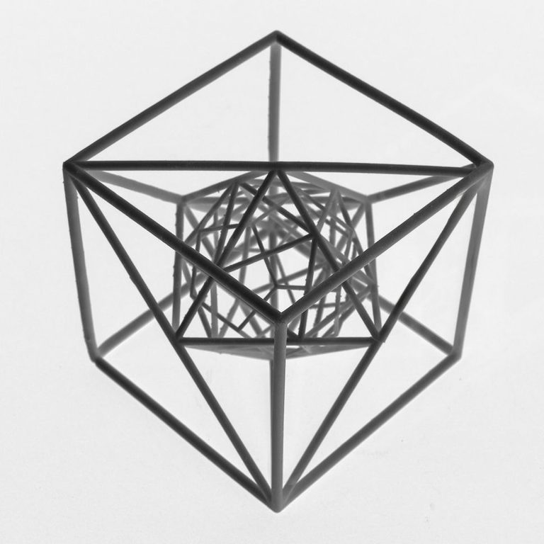 3D printed resin polyhedra interlace at a common center in a vertically compounded arrangement.