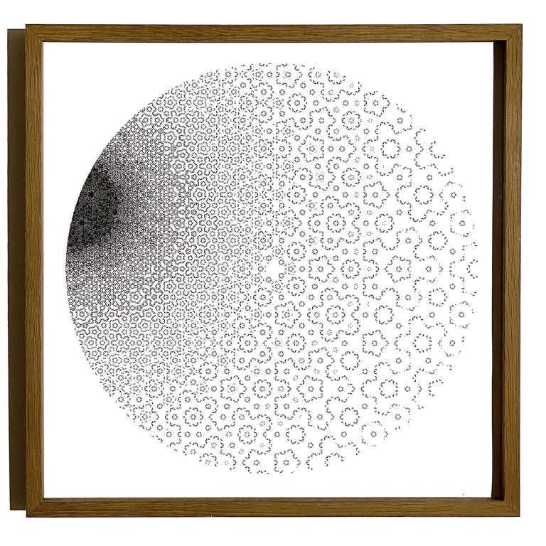 A c-print on paper in a wooden frame shows a circle of black dots that fade from dense to sparse.