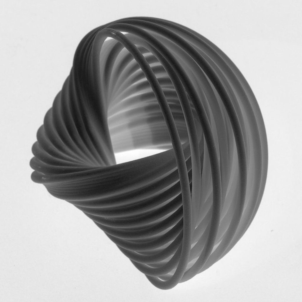 A 3D printed resin model shows interlocking curves in a spherical shape.