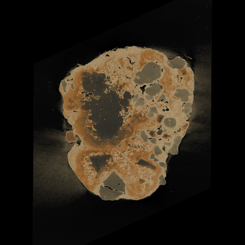 A video projection shows a cross-section of a sand grain with orange and grey voids on a black background.